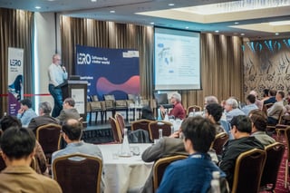 Photo of the crowd watching a talk by Dr Patrick Denny at the Lero Summit. 